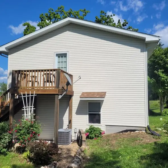 Same home with new siding installed, trimmed, and finished